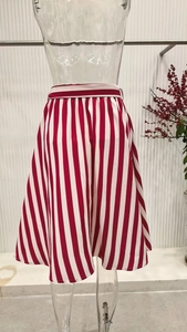 Detail of red and white vertical striped A-line skirt with a slim matching waist belt