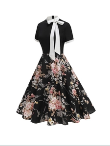 Vintage 1950s floral printed A-line dress with black bodice and white Peter Pan collar