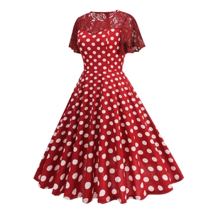 Detailed close-up of red polka dot dress featuring elegant lace panels and A-line cut