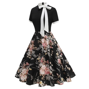 Detail of vintage 50s floral dress featuring a white bow collar and A-line print skirt