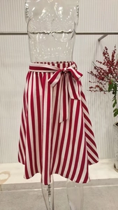 Detail of red and white vertical striped A-line midi skirt with decorative waist bow