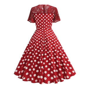 Back view of red polka dot dress featuring elegant lace panels and flared A-line skirt