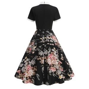 Detail view of the back of a vintage floral dress with hidden zipper and A-line silhouette