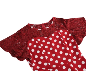 Detail of red polka dot dress featuring lace patchwork on the neckline and shoulders