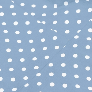 Close-up of blue cotton fabric with white polka dots and stitched seam detail