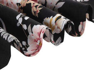 Close-up of floral print on black vintage dress fabric with fine stitching details