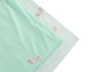 Close-up of pink flamingo embroidery on mint green mesh tulle high waist skirt