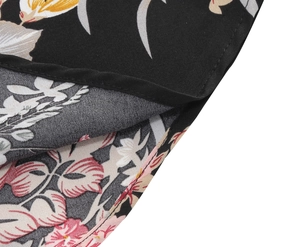 Detail of multi-color floral print on black fabric with reinforced stitched edges