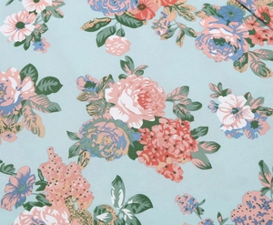 Close-up of floral print fabric featuring pink roses and orange flowers on light blue