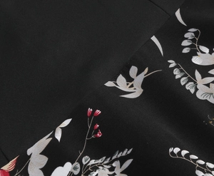 Detailed view of black fabric with vintage floral print and premium stitching quality