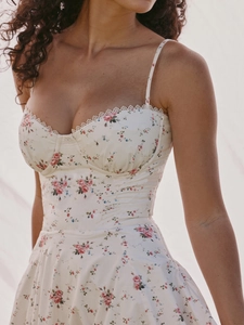 Close-up of floral slip dress featuring intricate white lace trim and corset-style bodice