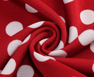 Macro view of red polka dot knit fabric texture with soft drape and flexible weave