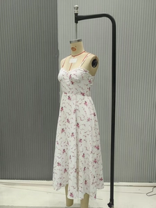 Detail of white floral chiffon maxi dress with lace neckline and pink floral patterns