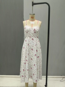 Detail of V-neckline and red floral embroidery on the white summer slip midi dress