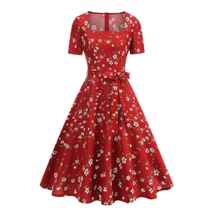 Detail of square neckline and waist tie on red floral retro dress with white patterns