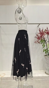 Detail of pink flamingo embroidery on high waist black double-layer mesh maxi skirt