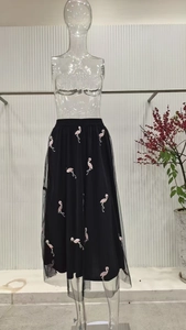 Close-up of pink flamingo embroidery on black double-layer mesh tulle skirt