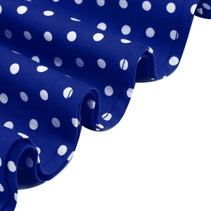 Close-up detail of blue fabric with white polka dots showing smooth cotton texture