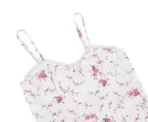 Close-up of floral embroidery and lace trim on the neckline of a vintage strap dress
