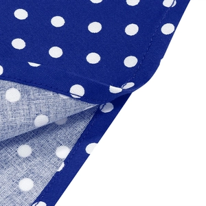 Detailed close-up of red polka dot cotton fabric showing fine stitching and texture