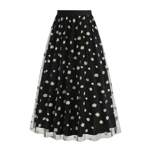 Detail of high waist elastic band and delicate white daisy print on black mesh skirt