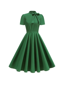 Elegante abito verde scuro con maniche a sbuffo, fiocco al collo e linea a trapezio