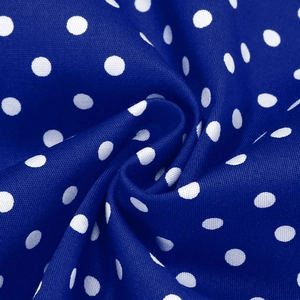 Macro shot of navy blue cotton fabric with white polka dots showing fine woven texture