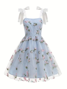 Detail of light blue mesh dress with pink floral embroidery and white satin bow straps