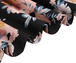 Close-up of floral print ruffle hem on a black vintage midi skirt showing fabric detail
