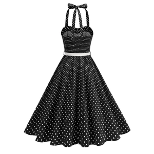 Detail of vintage red polka dot halter neck dress with a decorative bow and white waist belt