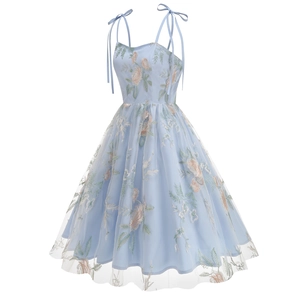 Detail of light blue embroidered dress with floral lace overlay and ribbon straps