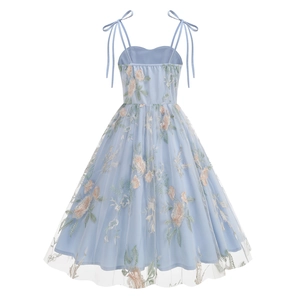 Detail of light blue embroidered dress featuring yellow floral lace and shoulder bows