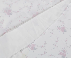 Close-up of floral embroidery on white vintage dress with professional hem stitching
