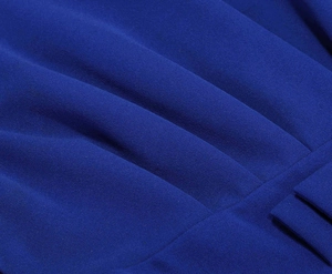 Macro shot of royal blue pleated fabric texture showing detailed accordion pleats