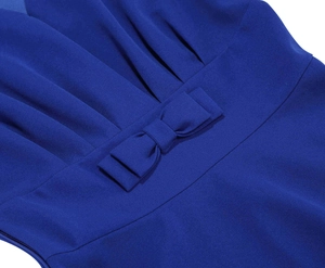 Detail of royal blue V-neck dress showing waist bow decoration and pleated chiffon fabric