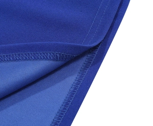 Detailed close-up of blue dress hem featuring neat stitching and textured fabric finish