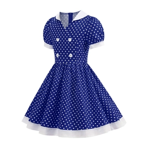 Detail view of royal blue polka dot girl dress with white collar and puff sleeves