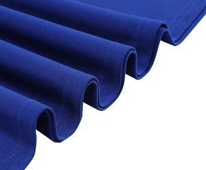 Detail of royal blue V-neck dress showing textured fabric and wavy pleated hemline detail