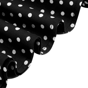 Close-up of black and white polka dot cotton fabric with high-quality hem stitching detail