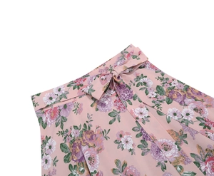 Close-up of pink floral midi skirt waist with a delicate bow knot and chiffon texture