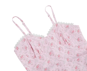 Detail of pink floral spaghetti strap top with white lace trim and V-neck design