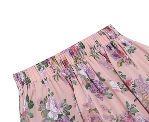Close-up of elastic waistband with pleats on light pink floral print midi skirt