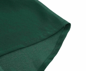 Macro detail of forest green chiffon fabric with precise single-needle hem stitching