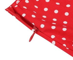 Détail d'une robe rouge à pois blancs montrant la fermeture éclair invisible de qualité