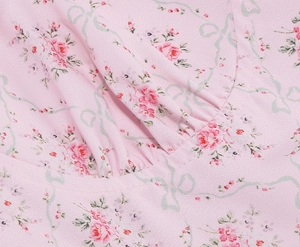 Detail of pink rose floral print and delicate pleats on vintage strap long dress