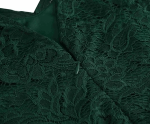 Macro detail of the invisible zipper and floral lace fabric on this dark green retro dress