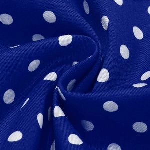 Close-up of royal blue polka dot fabric texture for girl's sweet French dress