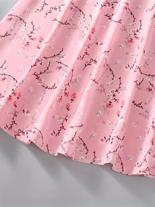 Close-up of pink floral chiffon fabric showing lightweight texture and vintage flower print
