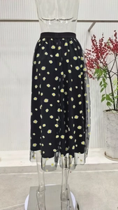 Detail of white daisy floral embroidery on black mesh tulle midi skirt layers