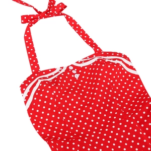 Detail of red polka dot dress neckline with white wavy lace and decorative buttons